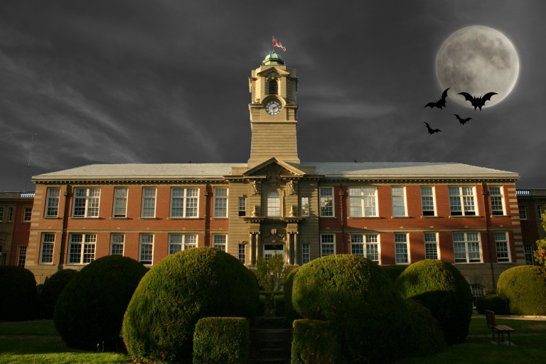 An image of the Young Building, with a moon and dark halloween sky. 